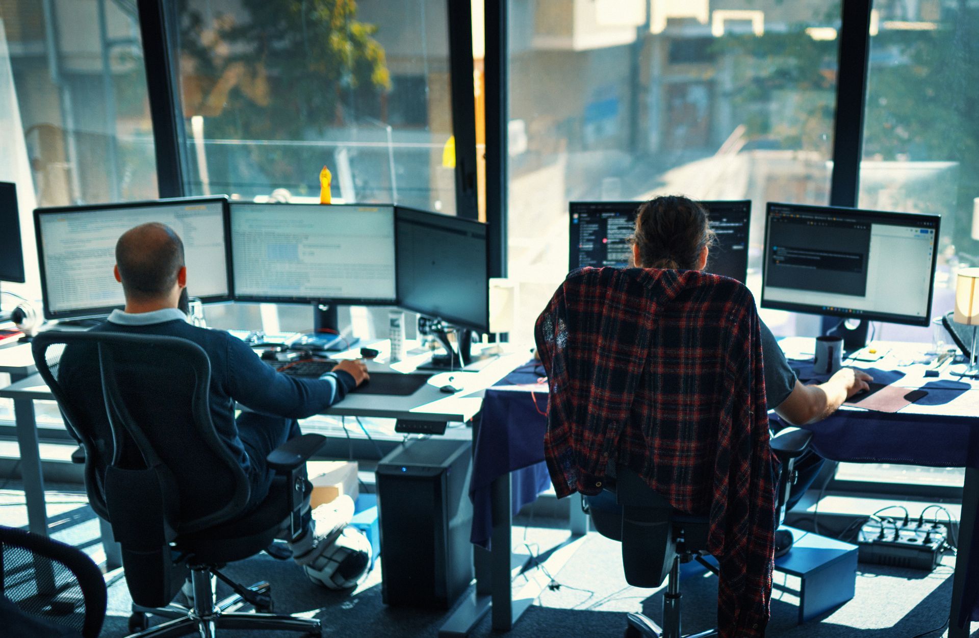 An IT team is working on multiple computers, providing business managed IT services.