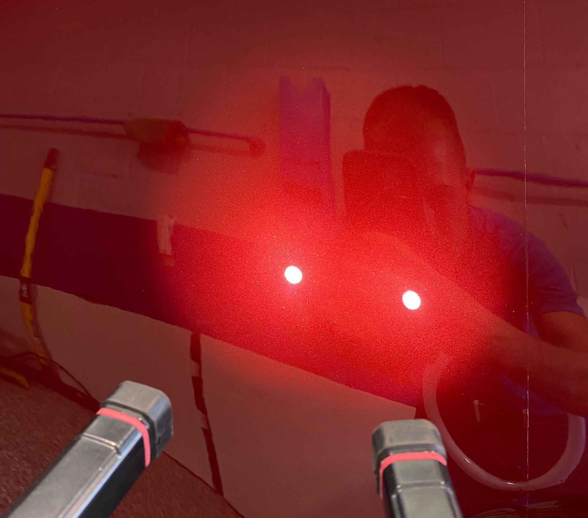 A man is standing in front of a red light.