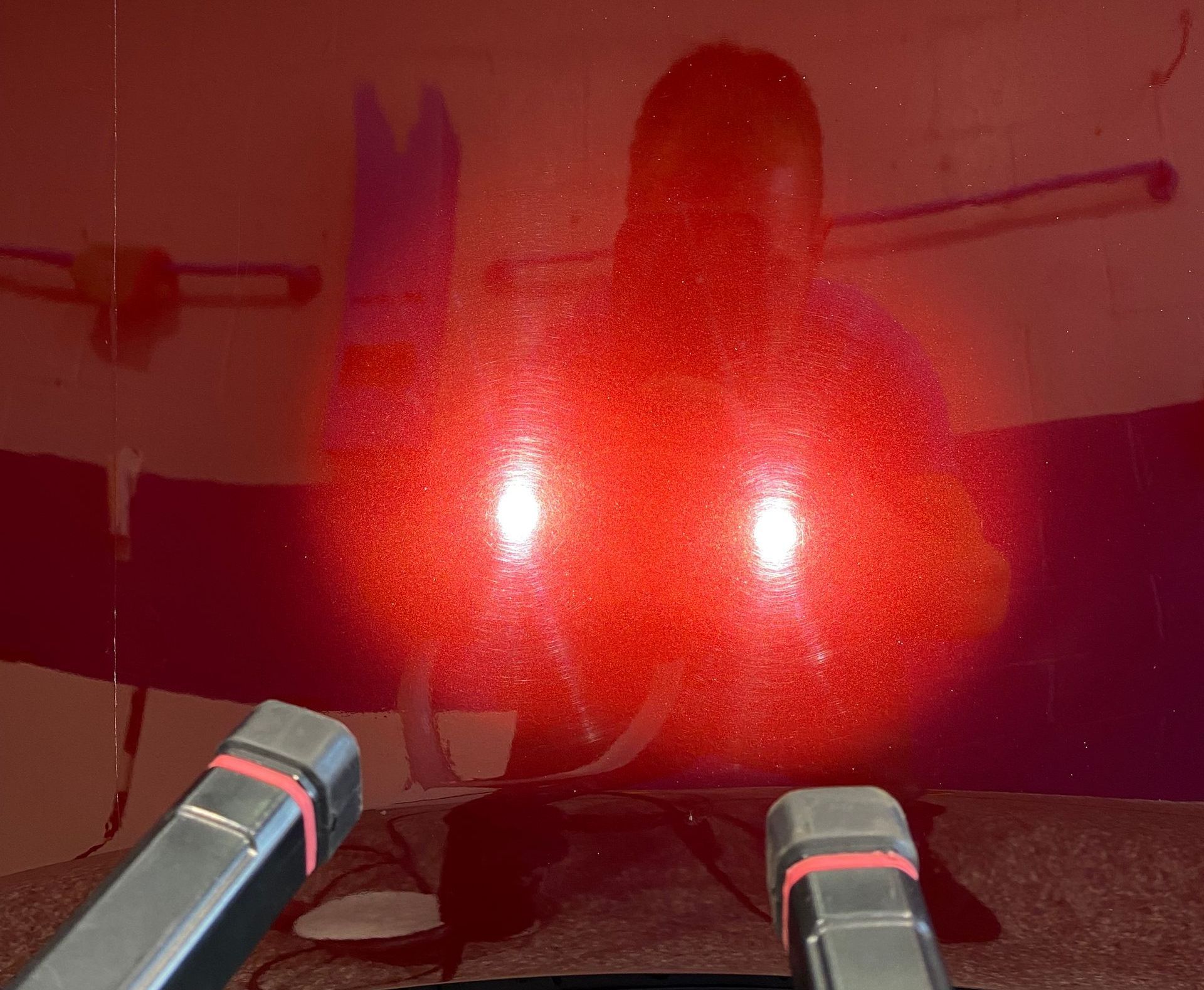 A red light is shining on a person 's face