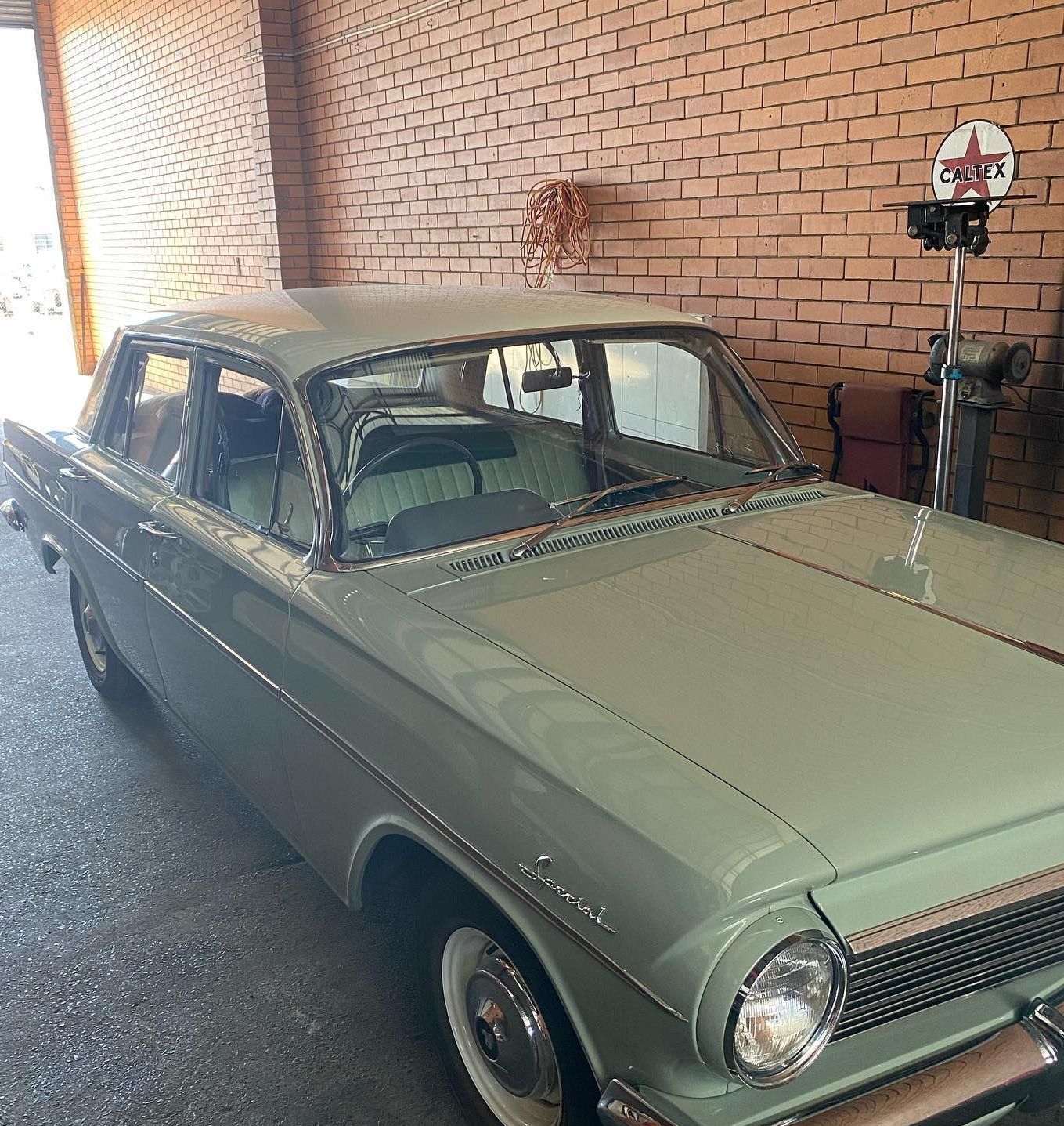 A White Van Is Parked In A Garage Next To A Brick Wall — Uncle Tonys Auto And Mechanical In Currumbin Waters, QLD