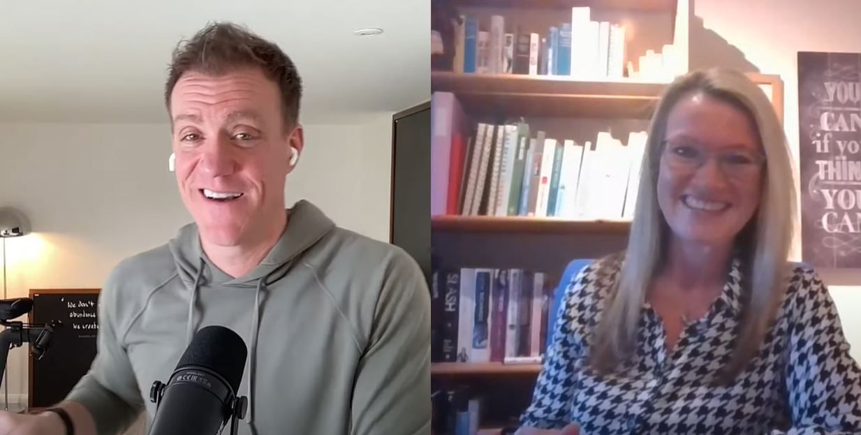 Two people on a video call, smiling. Man in a green hoodie, woman in a black and white blouse, both indoors.