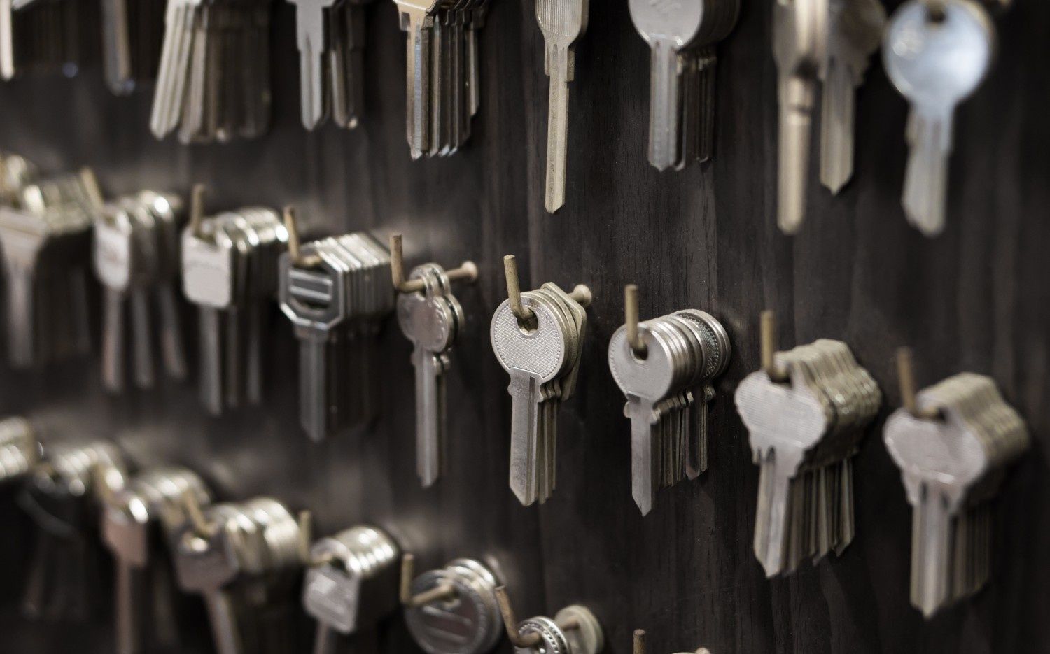Keys Hanging on A Dark Wall, Showcasing Various Shapes and Sizes — NORTHCOAST LOCKSMITHS & SECURITY In Forster, NSW
