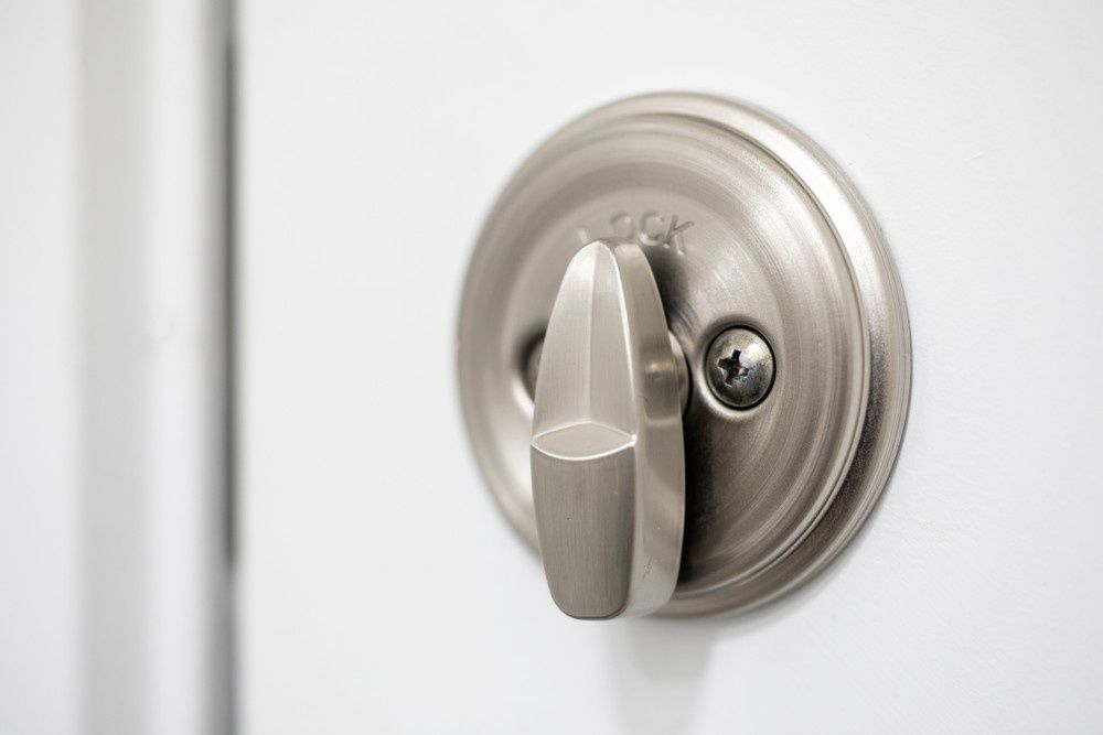 Silver Door Handle on A White Door, Showing the Lock Mechanism — NORTHCOAST LOCKSMITHS & SECURITY In Old Bar, NSW
