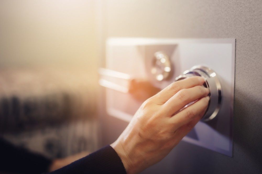 Woman's Hand Turning a Safe Dial, Opening the Door — NORTHCOAST LOCKSMITHS & SECURITY In Tuncurry, NSW