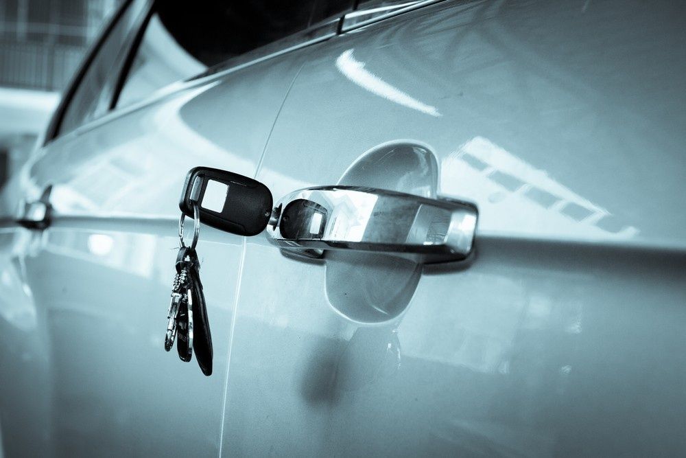 Car Keys Hanging from A Car Door Handle — NORTHCOAST LOCKSMITHS & SECURITY In Nabiac, NSW
