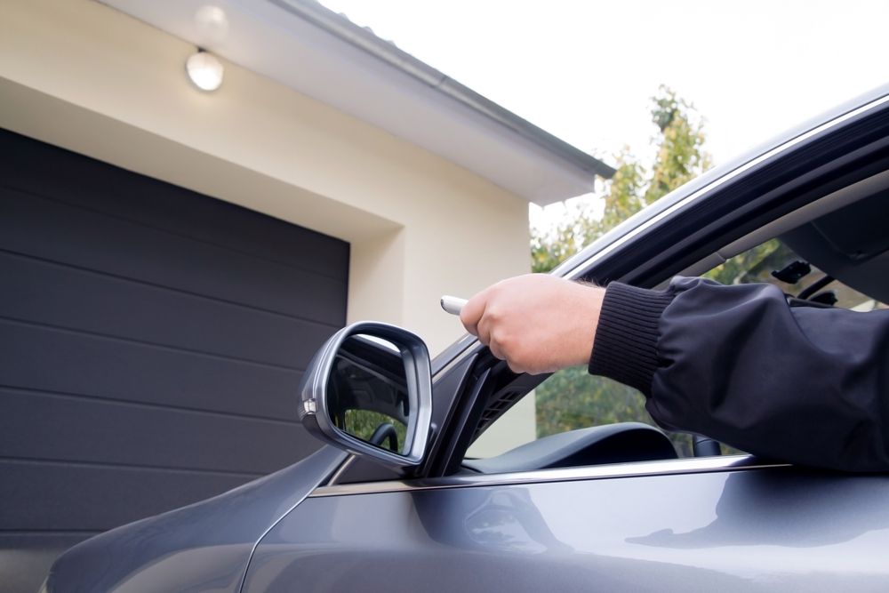 Person using a remote control to open a garage door from a car. — NORTHCOAST LOCKSMITHS & SECURITY In Tuncurry, NSW