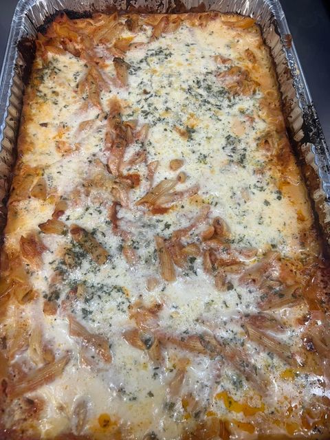 A casserole dish filled with a lasagna with cheese and onions.