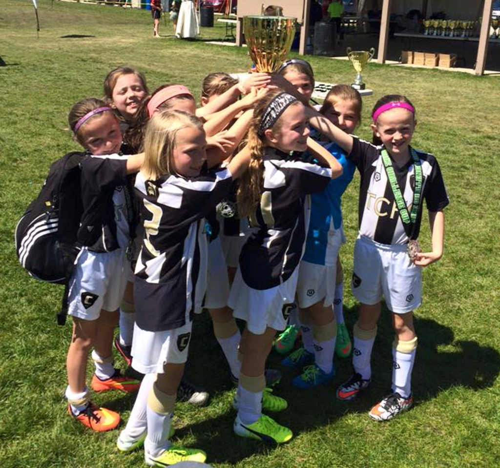 Team Challenger FC team celebrating with a trophy
