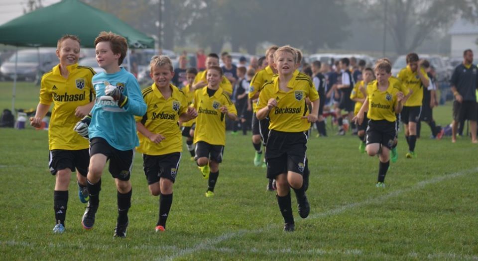Team Challenger FC team running on a field