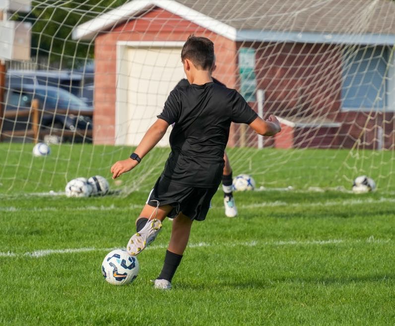 Team Challenger FC Junior Academy player shooting the ball