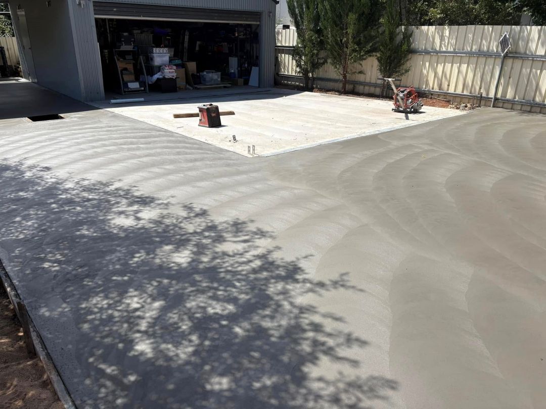 A Concrete Driveway is Being Built in Front of a Garage — All Aspects Concreting & Earthworks Pty Ltd in Dubbo, NSW