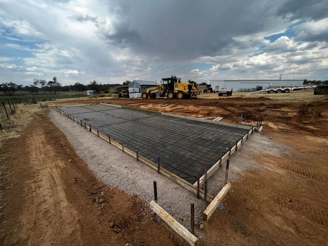 A Large Concrete Slab is Being Built on a Dirt Road — All Aspects Concreting & Earthworks Pty Ltd in Nyngan, NSW