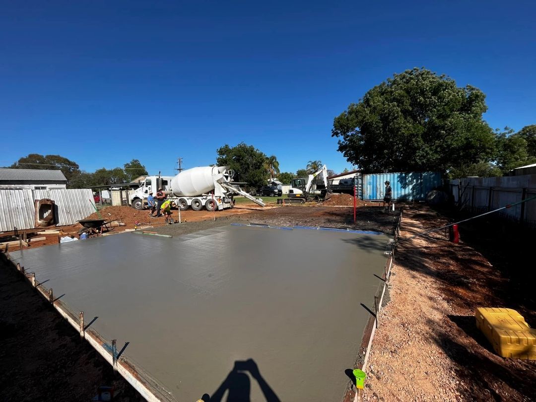 A Concrete Truck is Pouring Concrete Into a Concrete Slab — All Aspects Concreting & Earthworks Pty Ltd in Maitland, NSW