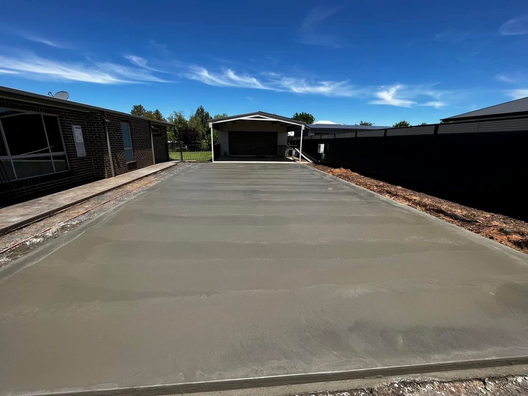 A Concrete Driveway is Being Built in Front of a House — All Aspects Concreting & Earthworks Pty Ltd in Dubbo, NSW
