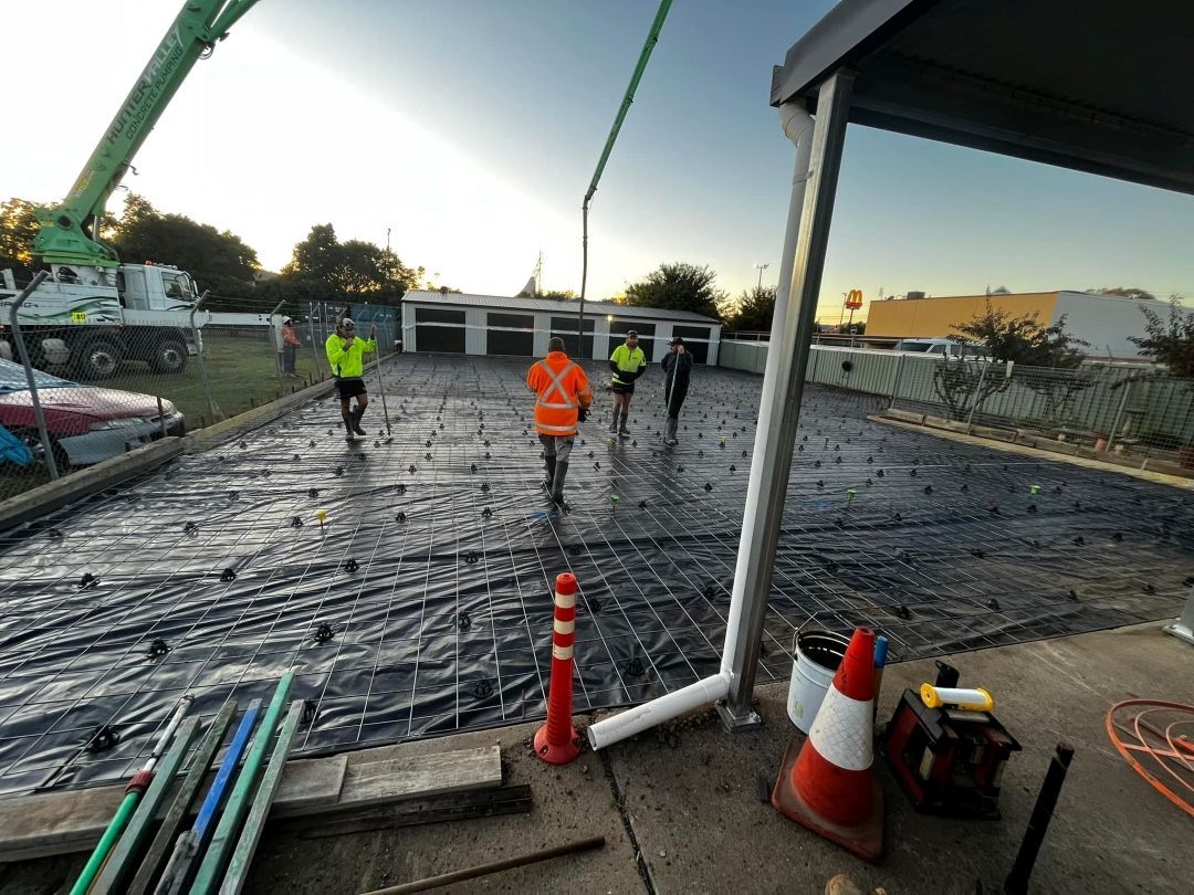 Group of Construction Workers Are Working on a Concrete Driveway — All Aspects Concreting & Earthworks Pty Ltd in Dubbo, NSW