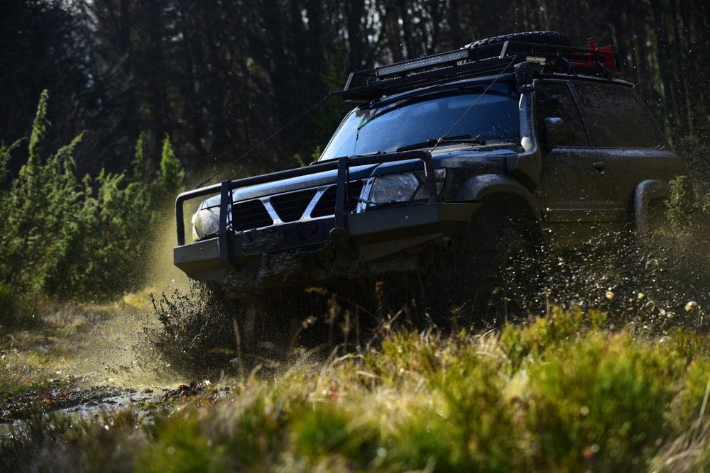 4x4 Off-Road Car On Path Crossing Puddle With Water Splash — Chrisp Performance in Emerald, QLD