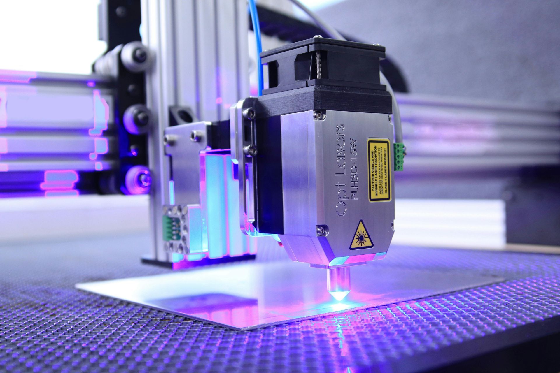 Laser cutting metal sheet with blue laser beam.