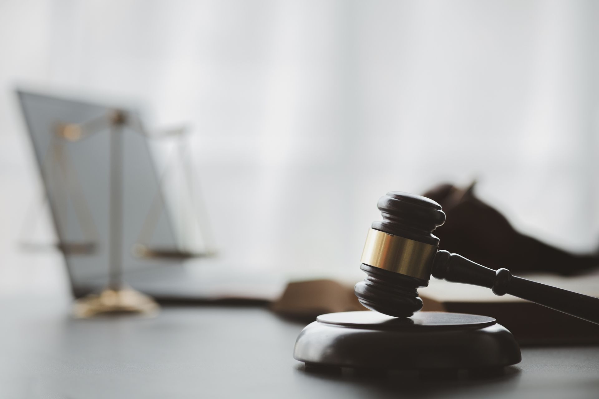 a judge 's gavel is sitting on a table in front of a laptop .