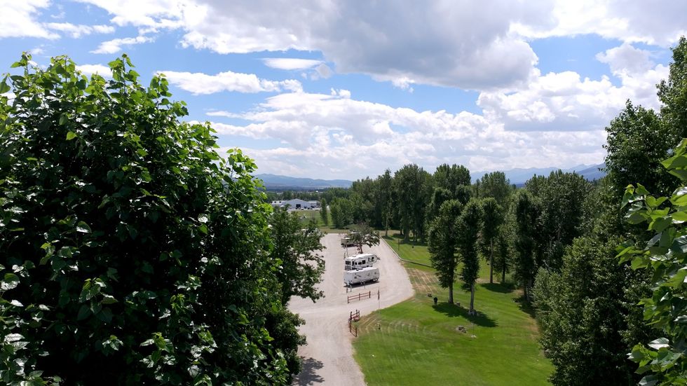 An aerial view of a parking lot surrounded by trees