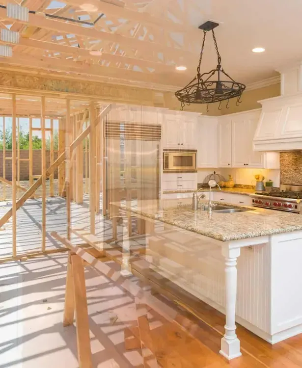 Bright modern kitchen with white cabinets, granite island, chandelier, and sunlit glass doors