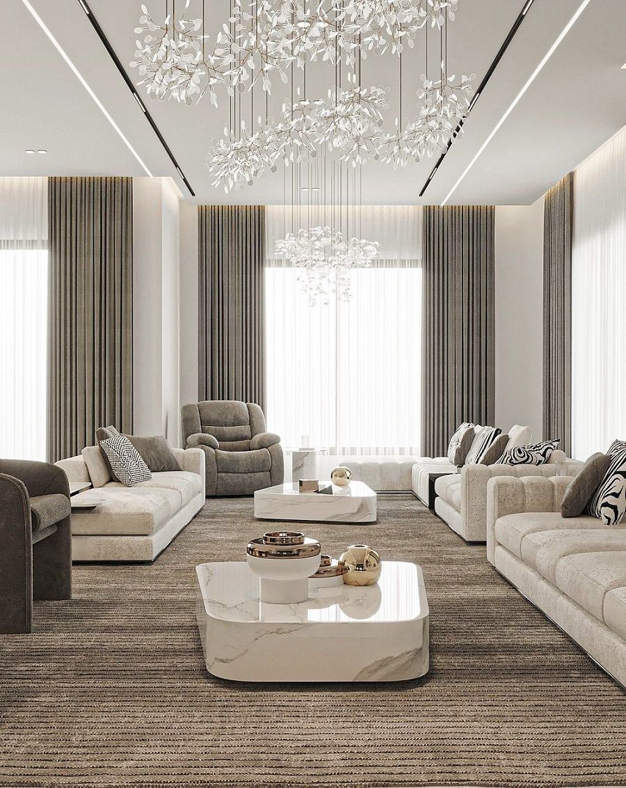 Luxurious neutral-toned living room with sofas, coffee tables, curtains, and crystal chandeliers