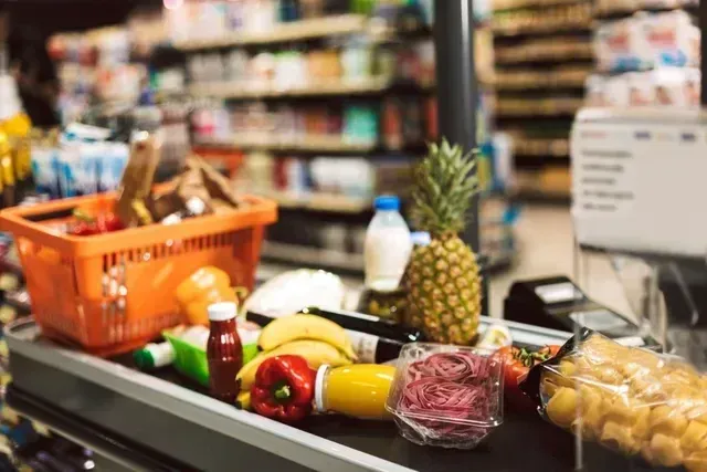Supermarket aisle with fresh produce representing FMCG retail experience and execution