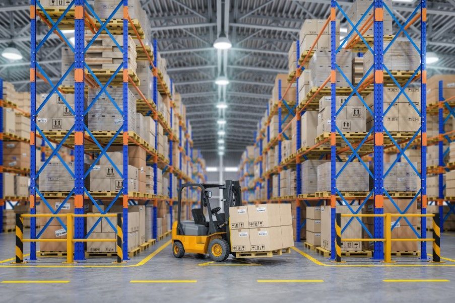 Warehouse aisle with shelves and forklift truck representing FMCG storage and logistics operations