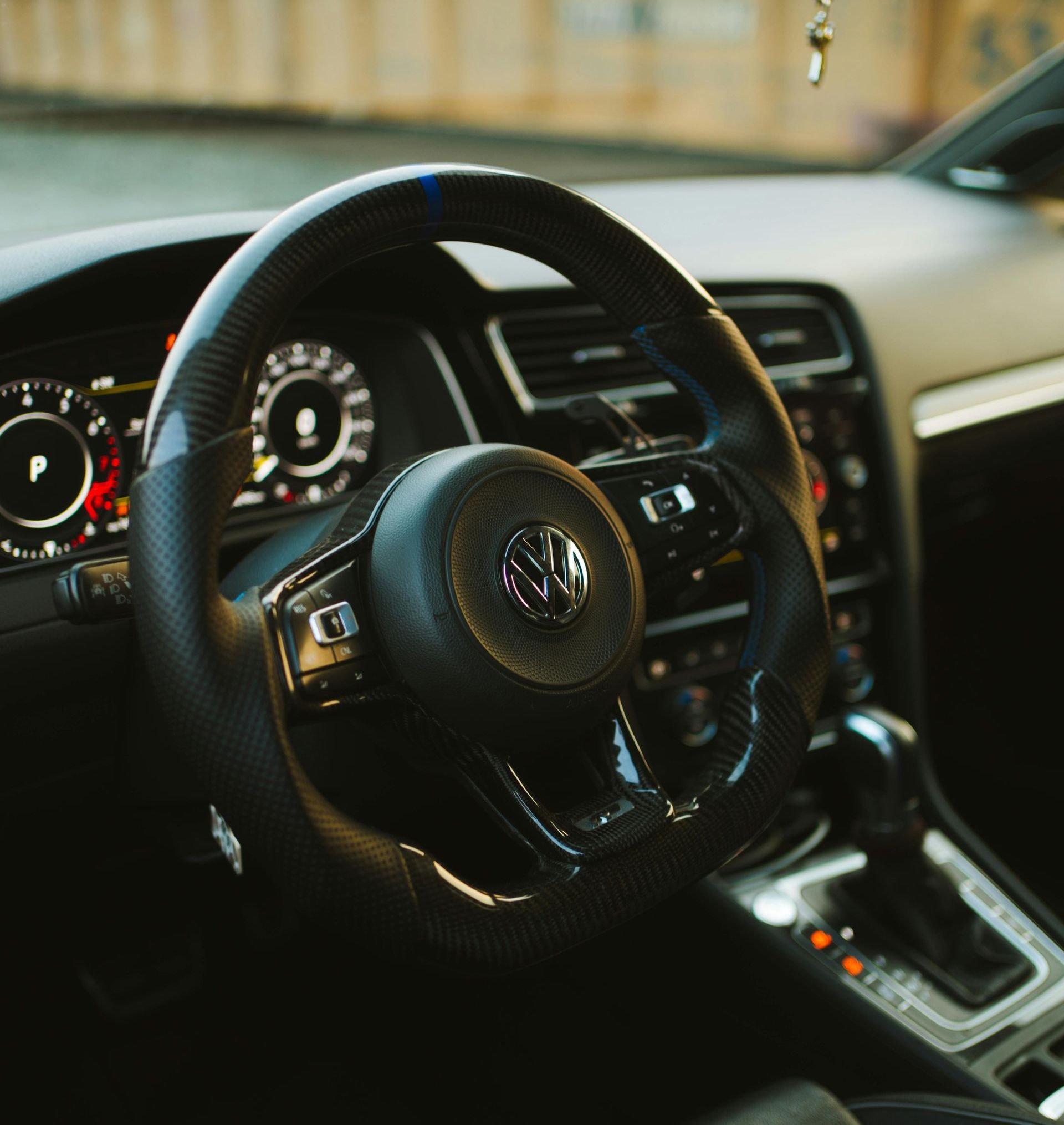 Close-up of a Volkswagen car interior with a steering wheel, dashboard, and center console.