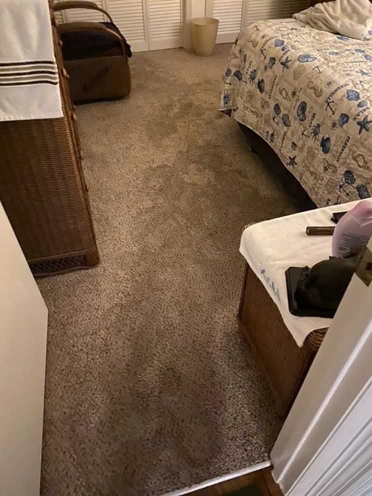A bedroom with two beds , a dresser , and a stool.