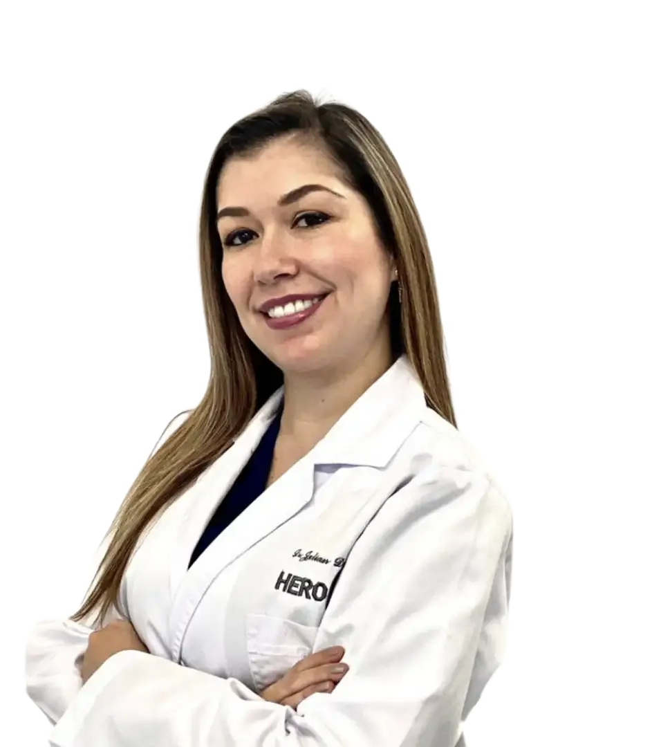 Smiling doctor in a white lab coat with arms crossed, standing against a white background