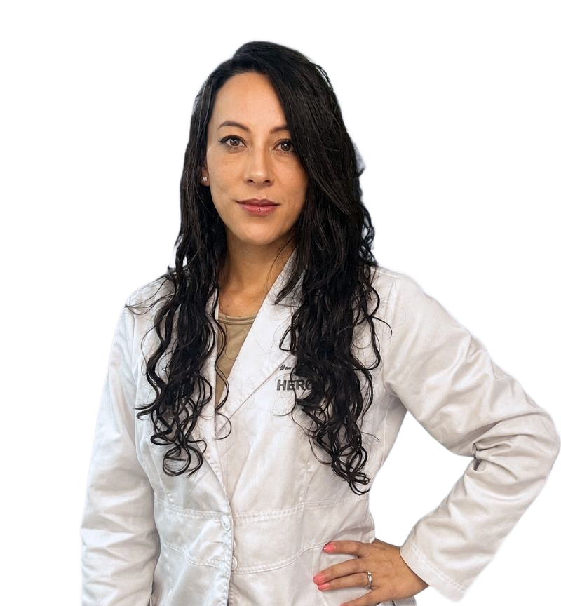 Smiling doctor in a white lab coat with arms crossed, standing against a white background
