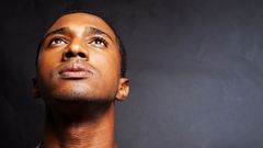 A close up of a man 's face looking up at the sky.