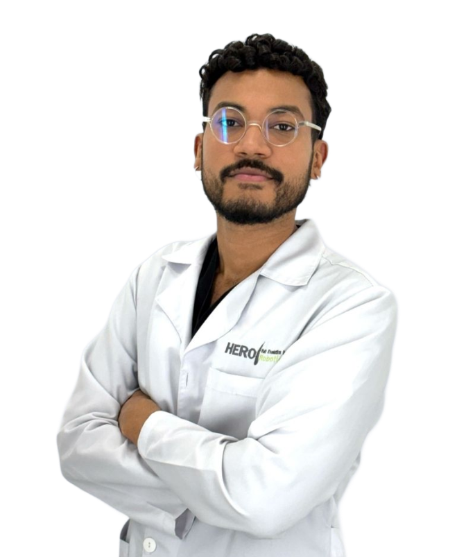 Healthcare professional in white lab coat standing with arms crossed against a white background