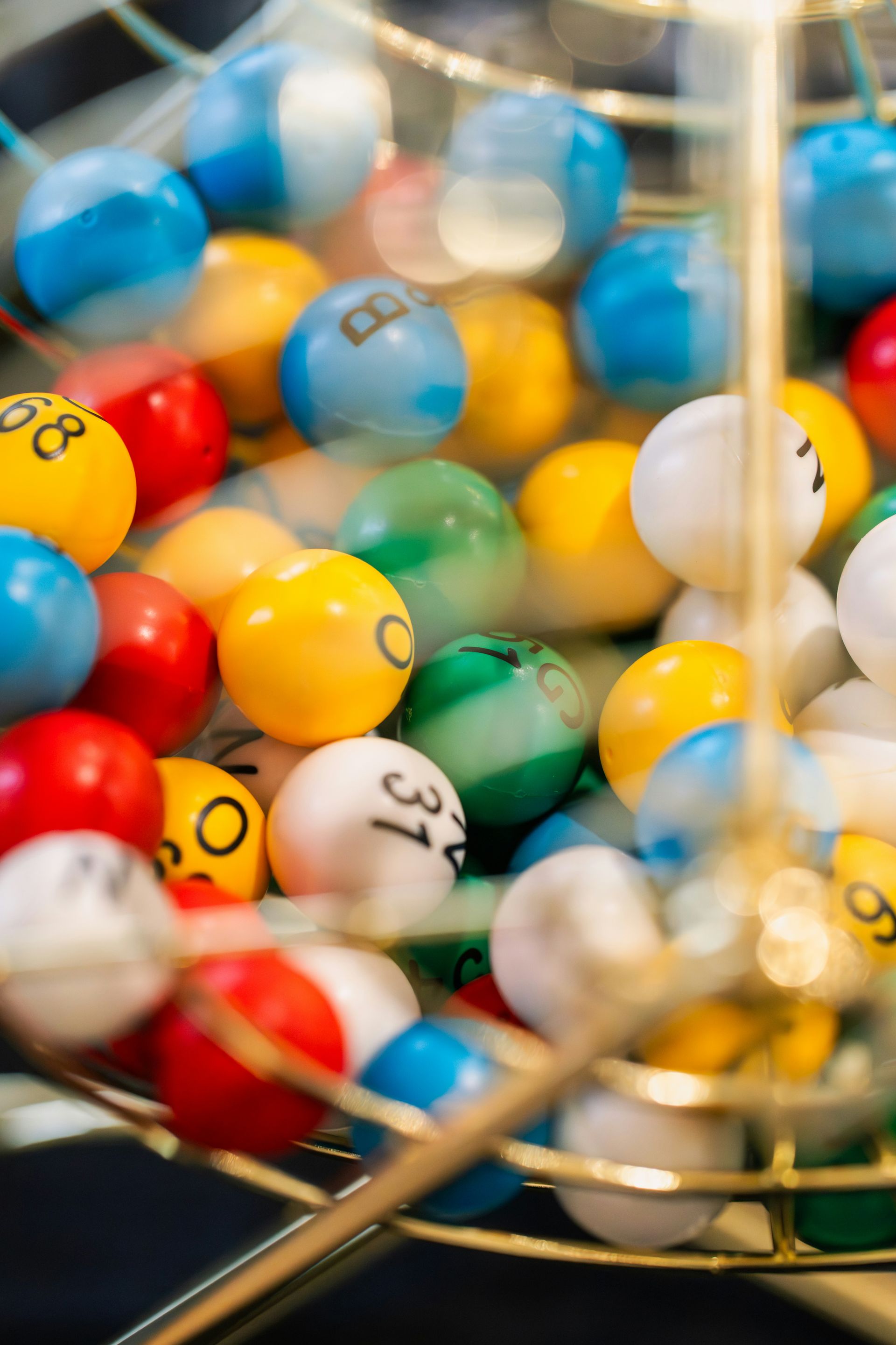 Close-up of colourful numbered lottery balls in a metal cage