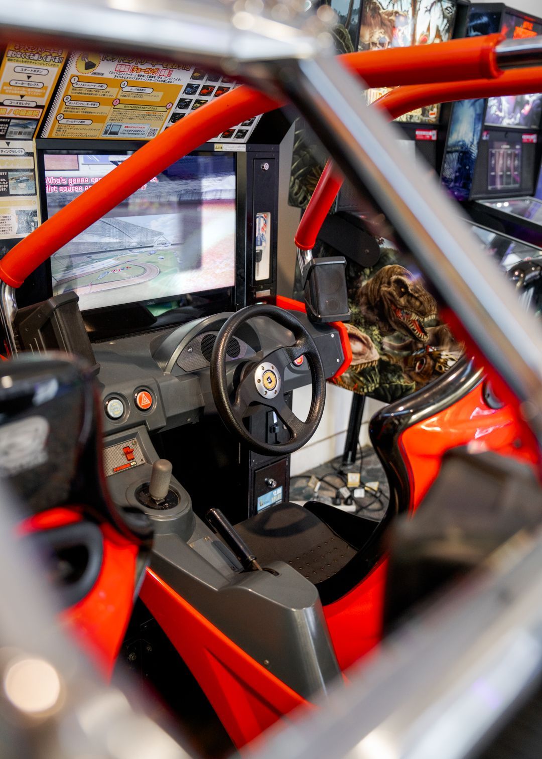Orange roll cage and steering wheel inside a race car cockpit game with dashboard and seat