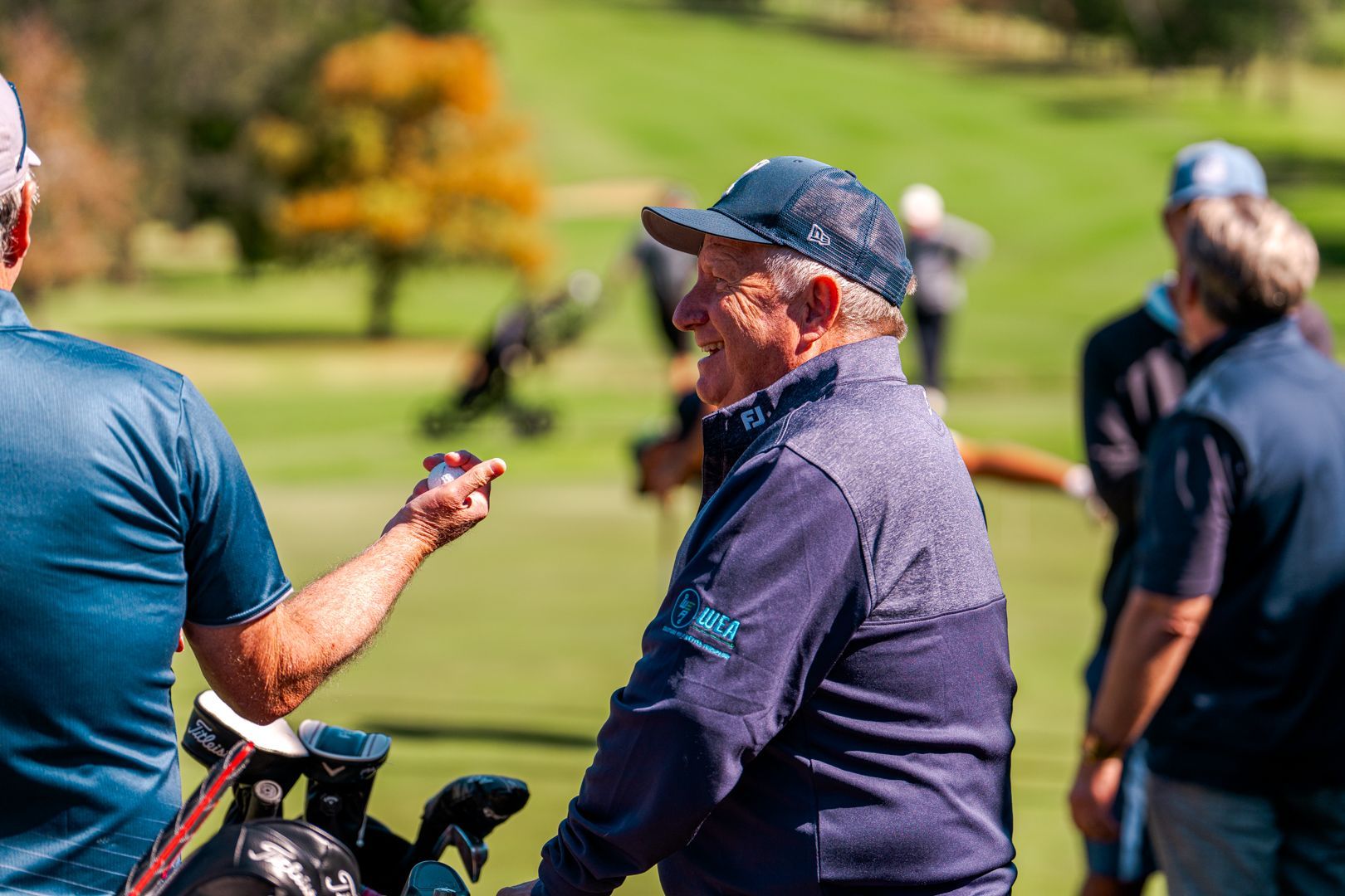Golfers talking on a sunny course