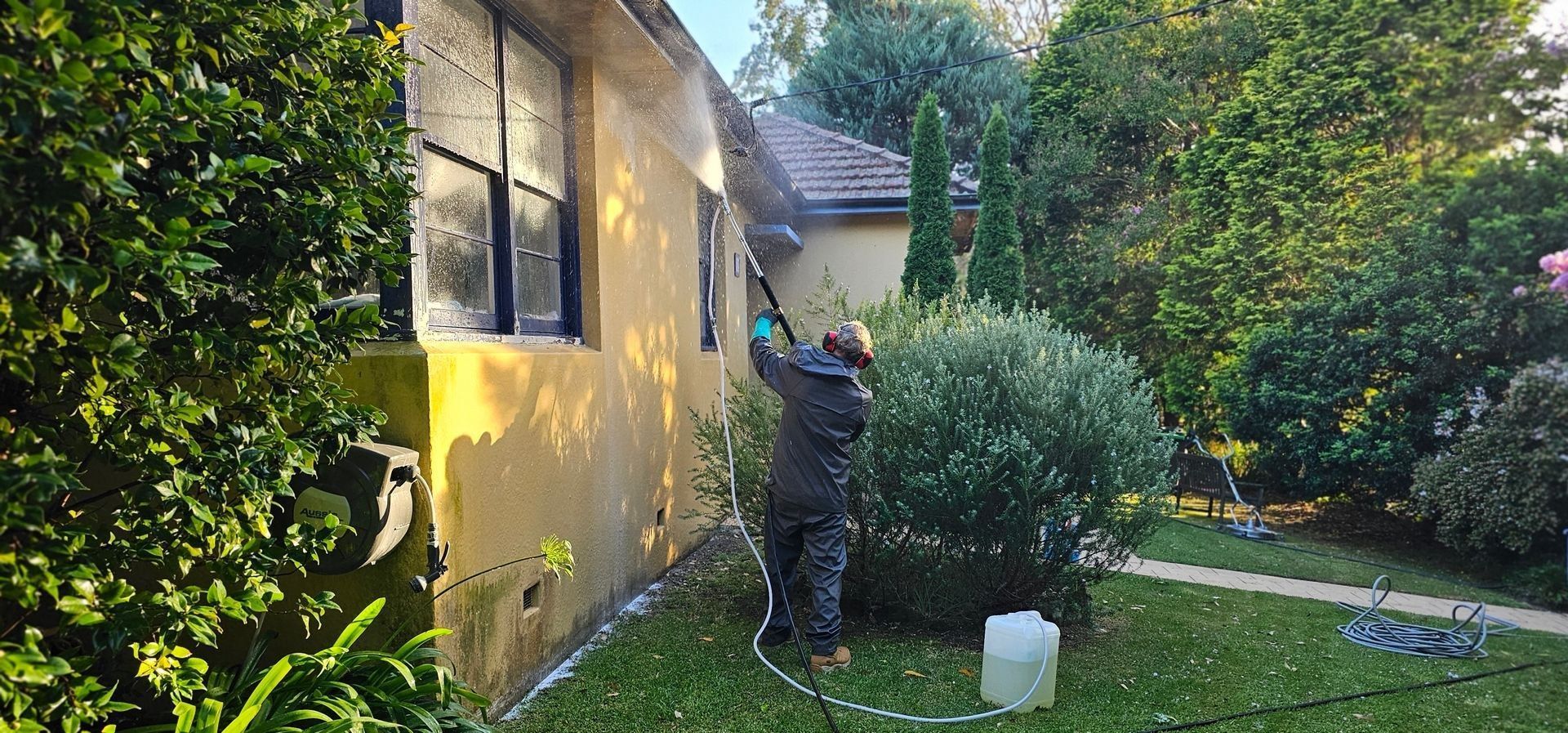Home Shine technician soft washing the outside of a Sydney house