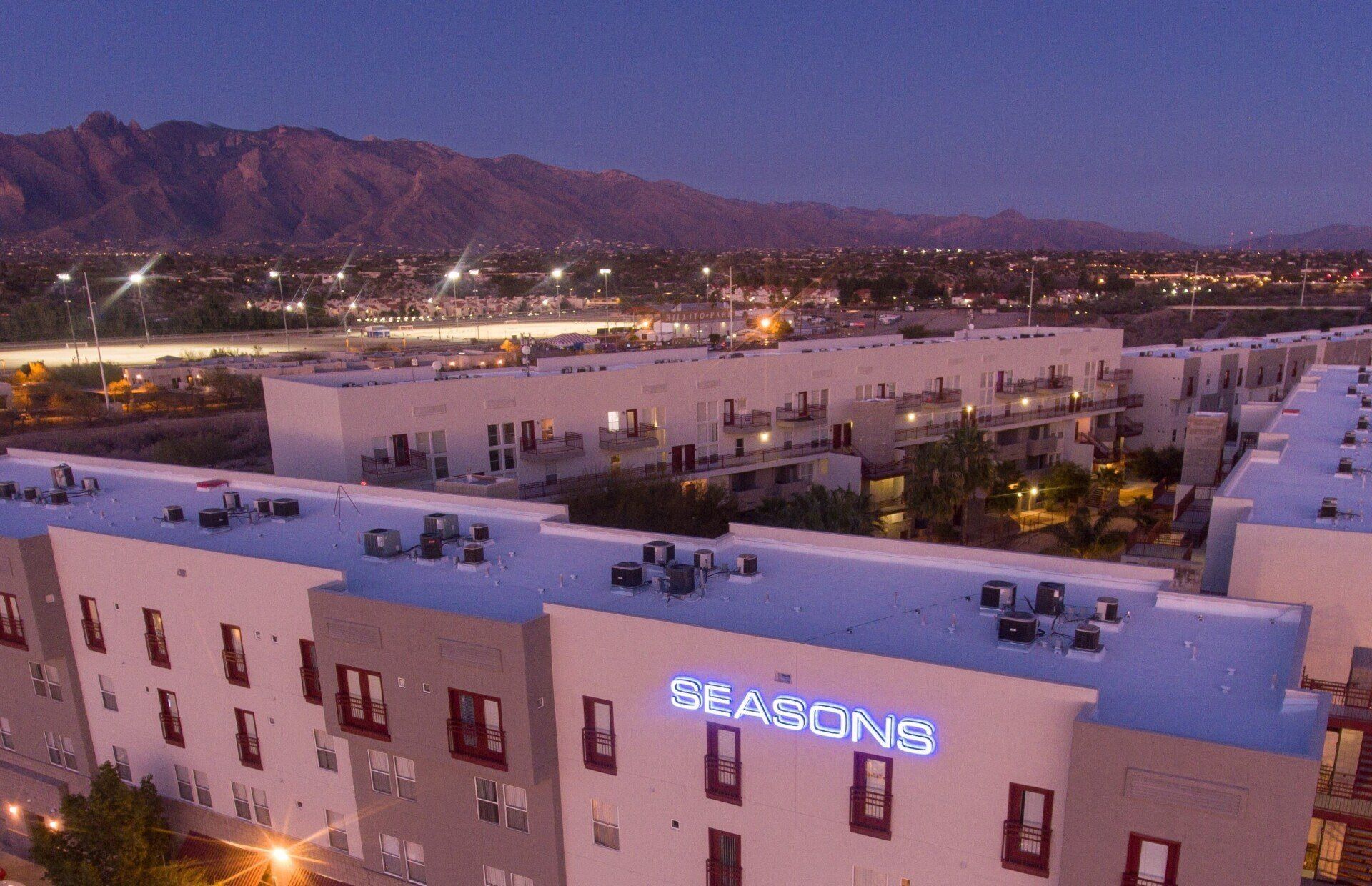 Check our availability for next school year! The front of The Seasons student living complex with an evening sky and a view of the mountains.