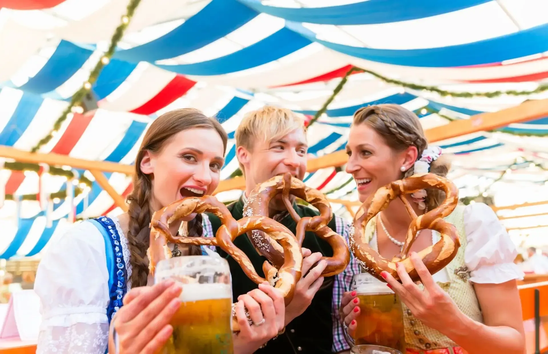 oktoberfest image of 3 people eating pretzels
