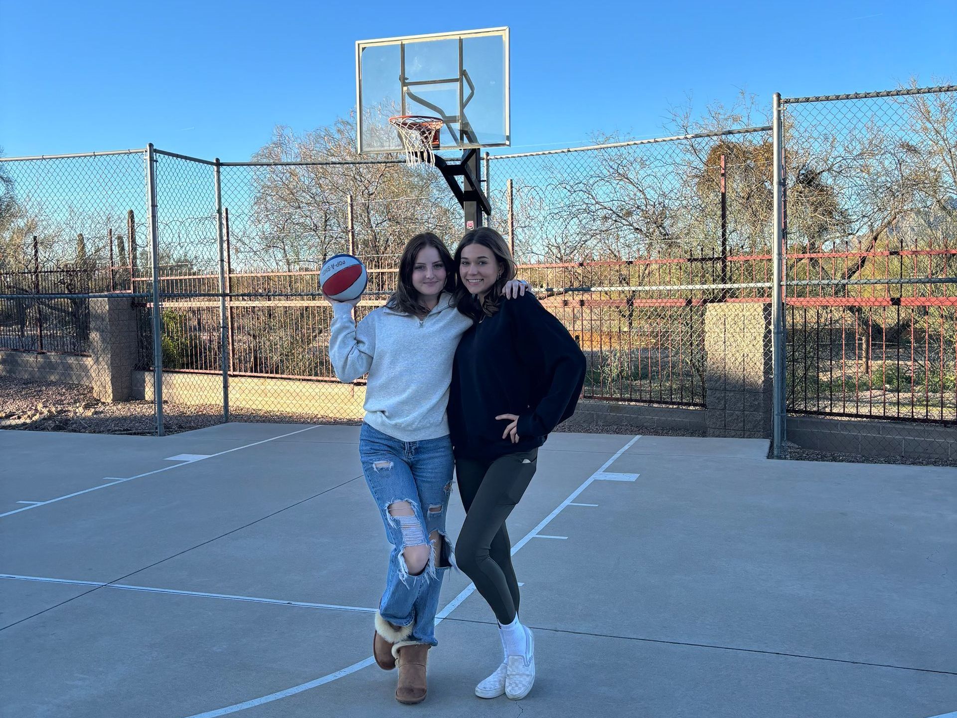 Move in with your bestie, sorority sister, or find a roommate with our matching process! Two female residents in cozy winter outfits pose with a basketball.