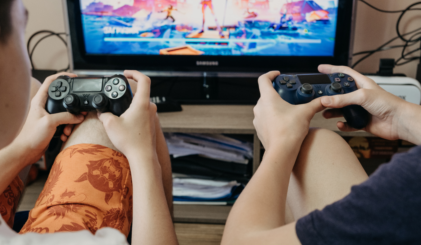 Two roommates are seen playing video games together.