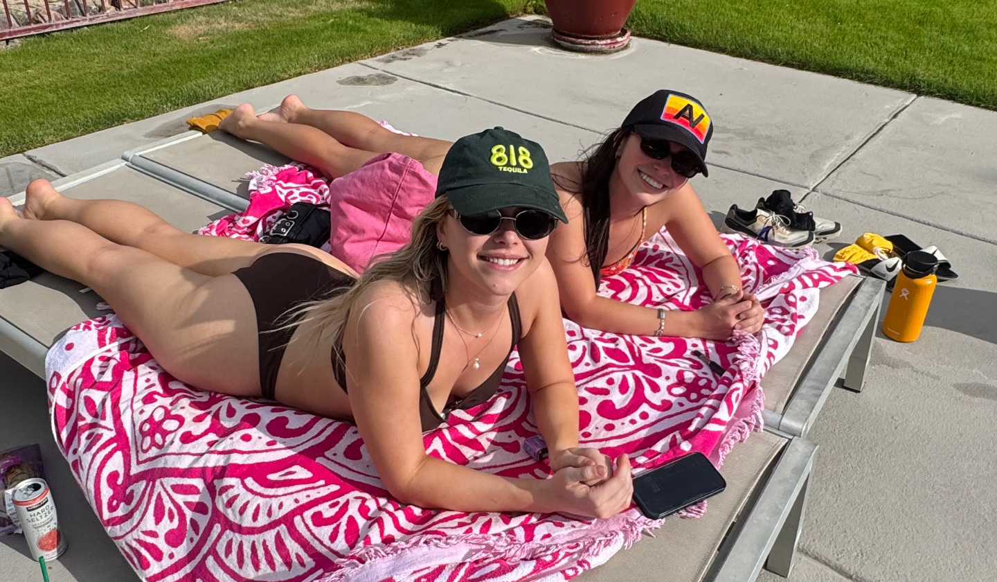 Check out the grills by the pool for a BBQ session! Two residents sunbathing in pool chairs by the resort-style pool at The Seasons Tucson.