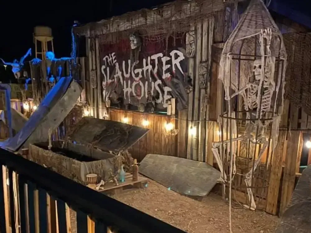 A caged skeleton and another emerging from an open casket at Slaughter House Tucson.