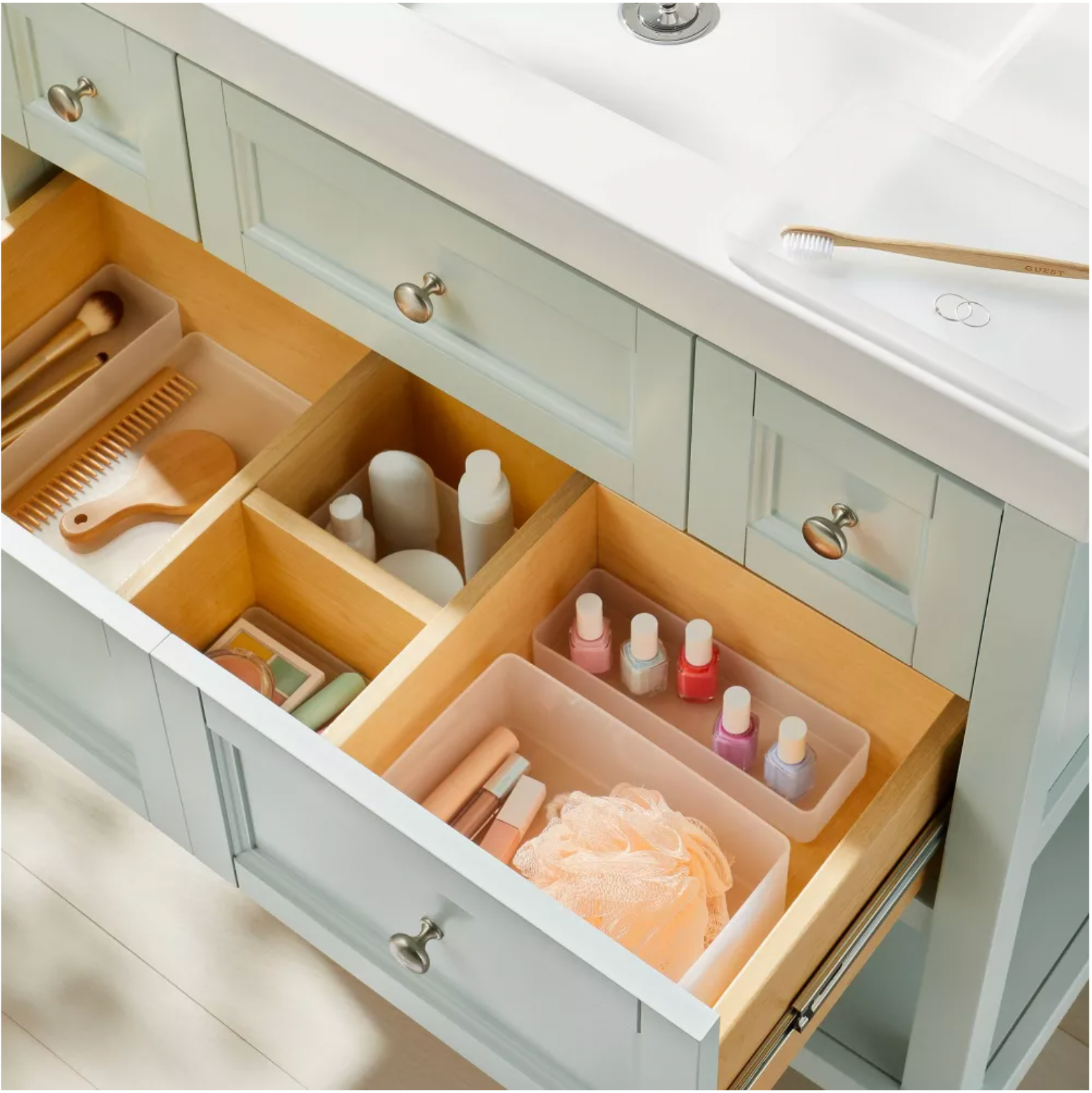 Hair and make-up brushes and neatly arranged beauty products in a Target storage container.