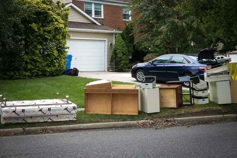 Household furniture and boxes sitting on a suburban curb on a St. John's street.