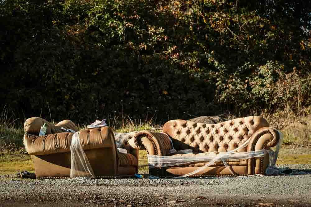 Old couch waiting to be picked up and removed from the street