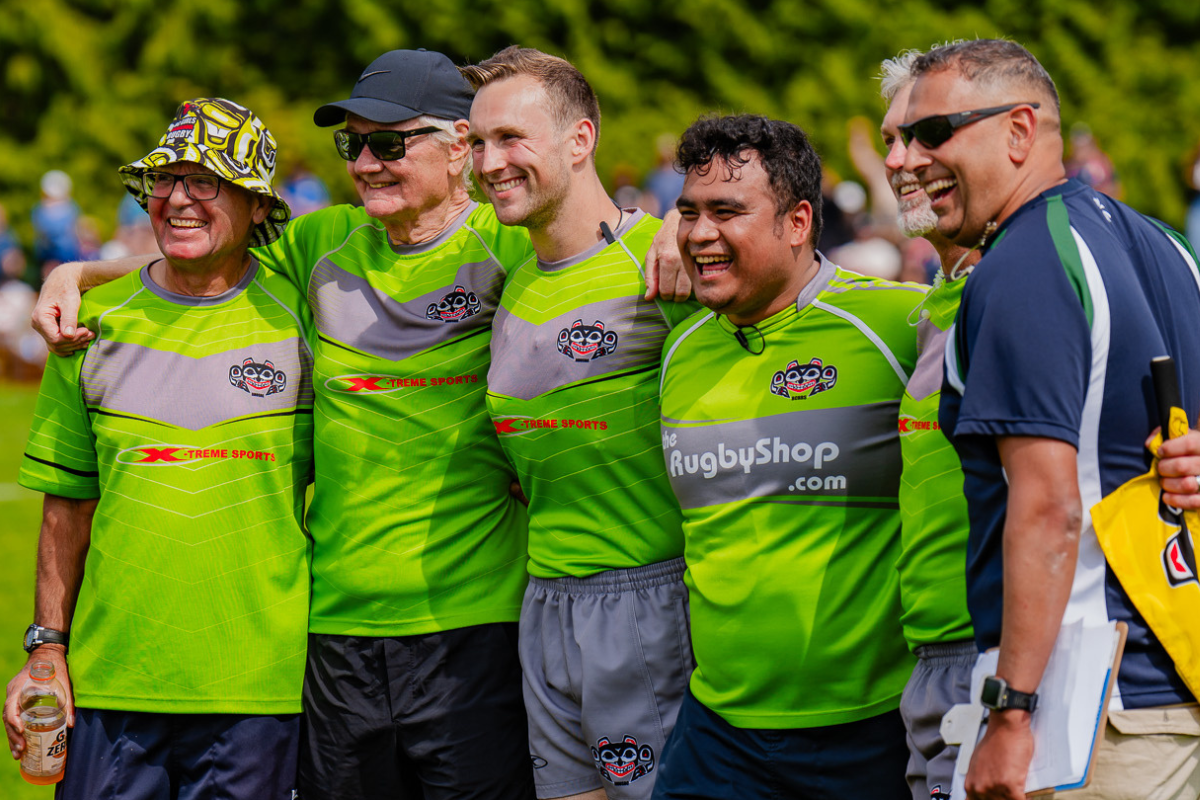 Five people in bright green sports jerseys smiling outdoors at a team event