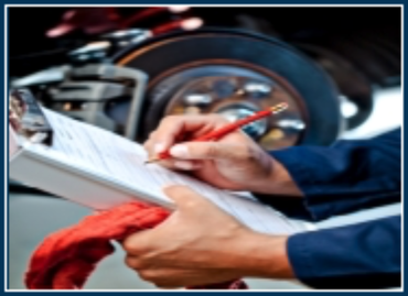 Mechanic writing on a clipboard beside a car wheel and brake assembly