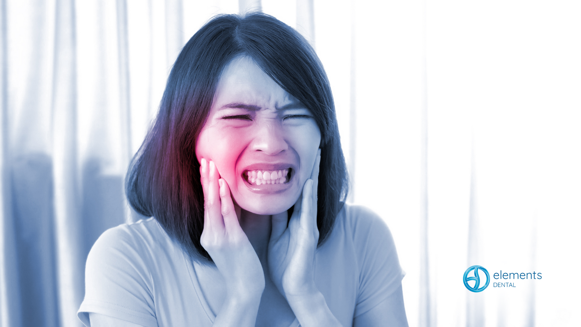 A woman is holding her face in pain because of a toothache.