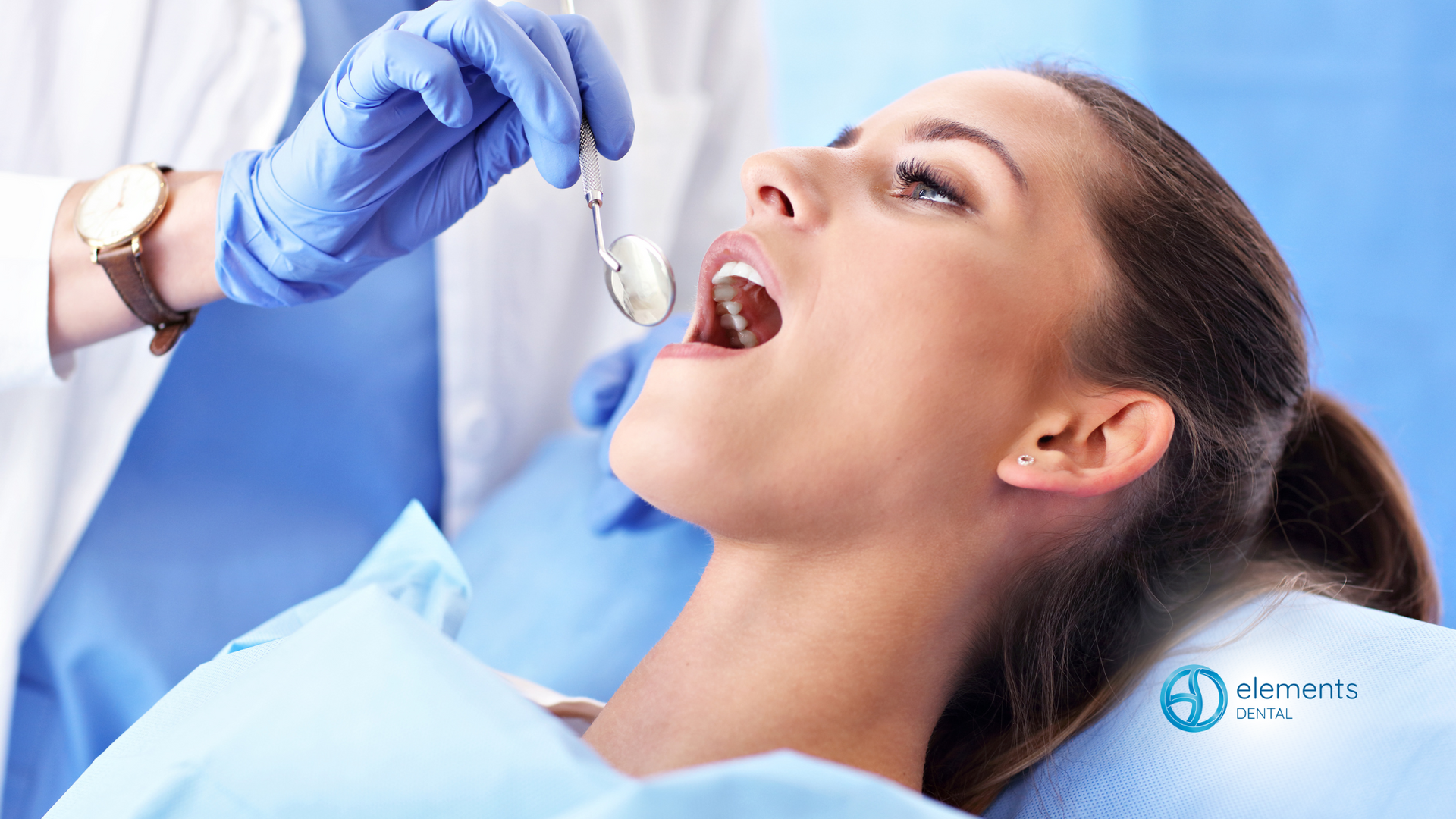 A woman is getting her teeth examined by a dentist.